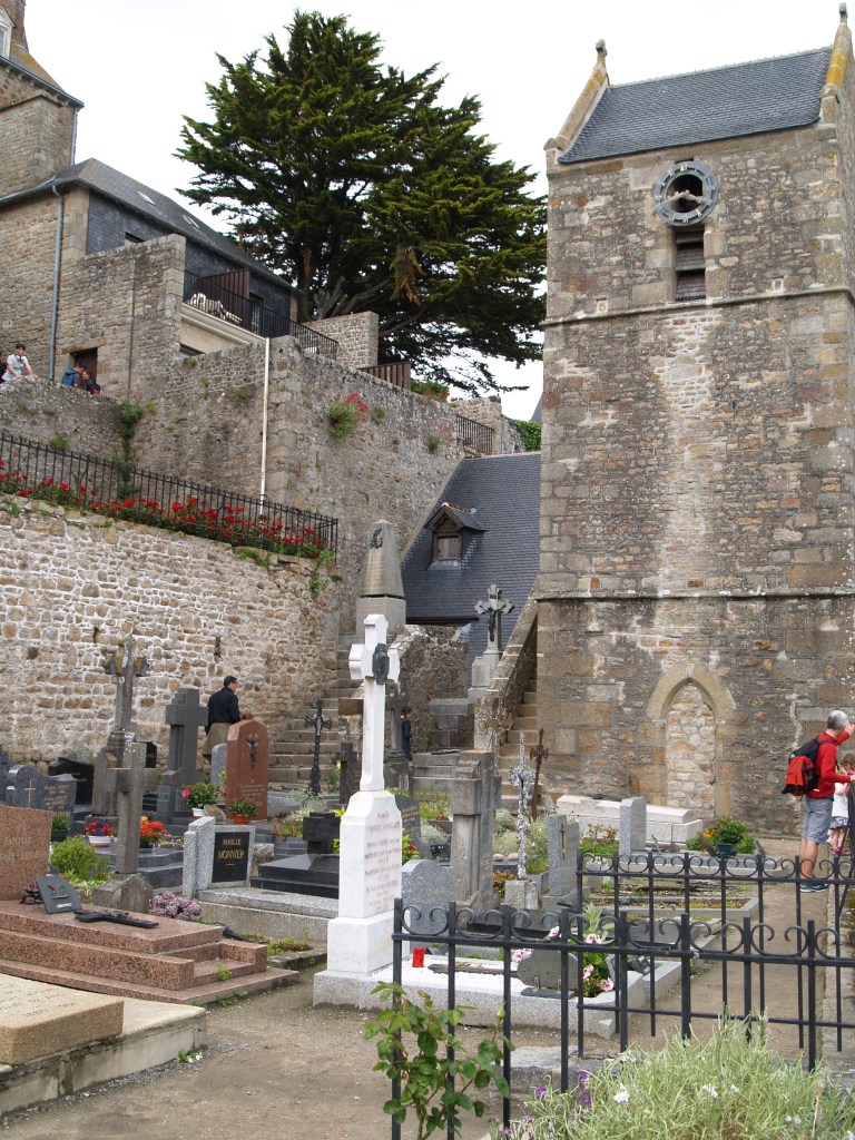 Graveyard in Normandy France - Mont Saint Michel - see how the windows of the town look right into the cemetery